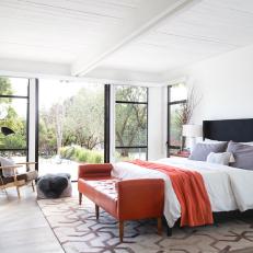 White Midcentury Master Bedroom With Orange Bench