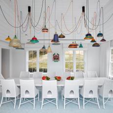 White Dining Room With Colorful Pendants