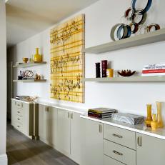 Wall With Floating Shelves and Yellow Art