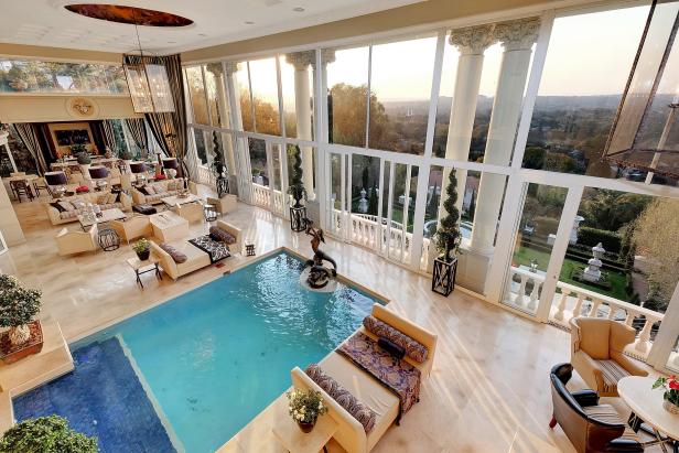 Indoor Pool With High Ceiling and Multiple Sitting Areas