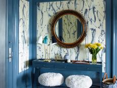 "Blue seems to be a color that almost everyone relates to and I can't really think of a shade of blue that I don't like," says designer Gideon Mendelson. "In this foyer on the Upper West Side of Manhattan we painted the paneling a strong blue and inset it with a fun, painterly wall covering from Porter Toleo. The rest of the furnishings fade into the background, letting the design of the paper shine."