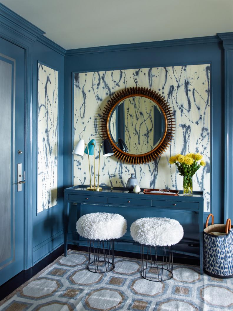 "Blue seems to be a color that almost everyone relates to and I can't really think of a shade of blue that I don't like," says designer Gideon Mendelson. "In this foyer on the Upper West Side of Manhattan we painted the paneling a strong blue and inset it with a fun, painterly wall covering from Porter Toleo. The rest of the furnishings fade into the background, letting the design of the paper shine."