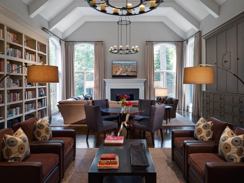 Large, open spaces can be wonderful, but they're not always easy to manage: too often, they feel empty and cold, without any sense of definition. But not this multipurpose family room, which is reminiscent of a the reading rooms of grand European estates. Designer Stephanie Wohlner says, "by adding the bookcases, a tall storage unit, ceiling beams, and three seating areas, we were able to change the dynamics of the entire room, adding layers of warmth and a sense of cohesiveness."
