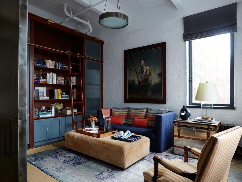 To give a bachelor's industrial downtown-New York City loft the "rich elements of a membership club," designer Brad Kreftman set an appealing mix of furnishings, vintage finds, and custom-designed pieces against a backdrop of exposed brick and pipe. "The result is an eclectic, inviting space," he says. "The study easily converts from a sitting room to an extra bedroom with a couch that folds out into a bed and a closet space in the corner for hanging clothes."