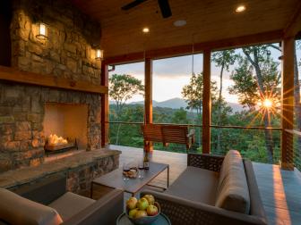 Tucked into the mountainside at nearly 4,300 feet in elevation, this Western North Carolina home blends Modern and Craftsman styles beautifully, seamlessly balancing aesthetics, comfort and function. “Taking careful consideration of the site of this home was an integral part of the design process, and it paid off, with breathtaking views from almost every room,” says architect Amy Conner-Murphy. “Even the outdoor living space is show stopping, with features such as cable railing, wood-look tiles, natural heavy timbers, and a neutral palette punctuated with hints of bolder color and texture.”