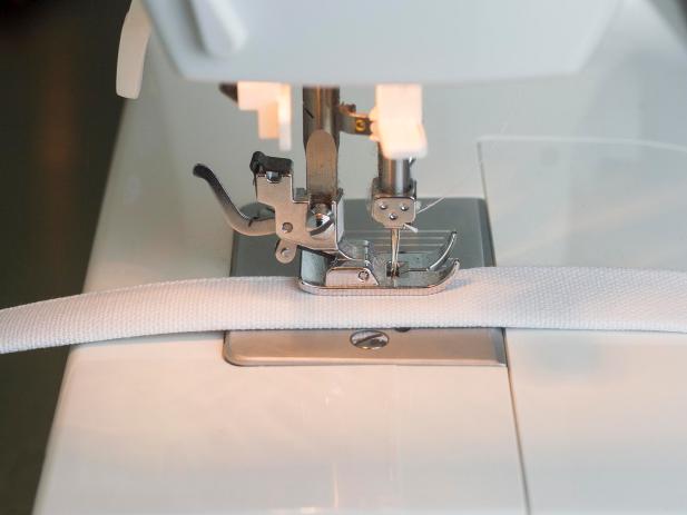 Cut a piece of strap fabric to 8” x 15-1/2”. Fold it in half lengthwise and press it. Fold both raw, long edges into the center to meet at the crease and press. Fold the two sides together with the raw edges on the inside. Press again.