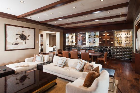 White Seating and Wine Storage Wall in Neutral Contemporary Basement