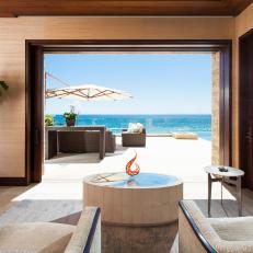 Neutral Contemporary Living Room With Retractable Doors and Ocean View