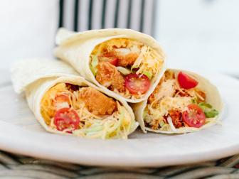 Here's a super easy idea for game day. These delicious buffalo chicken wraps feature a hint of buffalo spice, cooled off by the ranch and fresh vegetables. They are sure to be a crowd favorite. Pre-make, wrap in parchment paper and store in the cooler, or setup a wrap making station at your tailgating party.