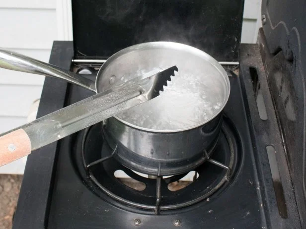 Cleaning dirty grilling utensils.