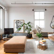 Spacious Modern Loft Living Room Featuring Neutral Furniture and Sleek, Selective Decor