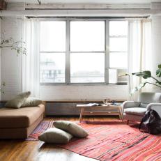 Bohemian Sitting Room Featuring Multicolor Rugs, Backless Bench and Natural Light in Modern Loft 