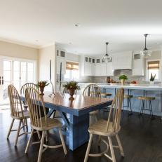 Spacious, Neutral, Transitional Kitchen With Muted Blue Accents, Simple Dining Chairs and Dark Hardwood