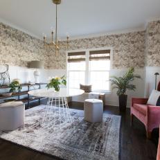 Eclectic Living Room Showcasing Neutral Patterned Wallpaper, Blush Velvet Chairs and Modern Dining Table