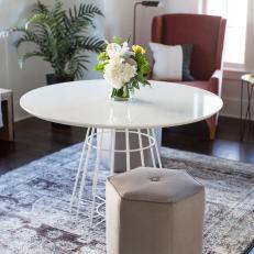 Small, Modern Dining Table With Hexagon Upholstered Stools Over Faded Pattern Area Rug