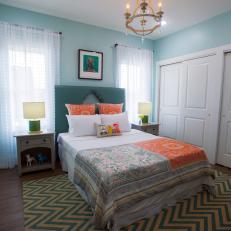 Contemporary Blue Bedroom with Orange and Green Bed Linen 