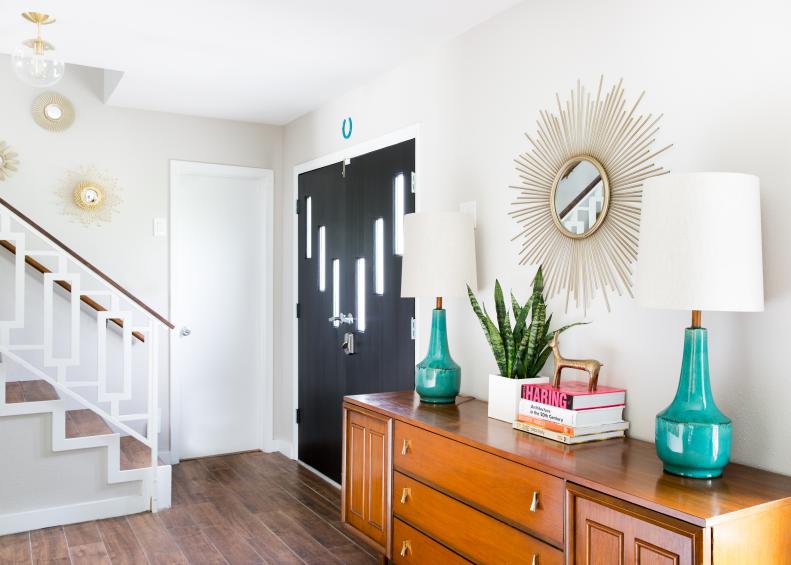Midcentury Modern Entry With Wood Buffet and Starburst Mirror