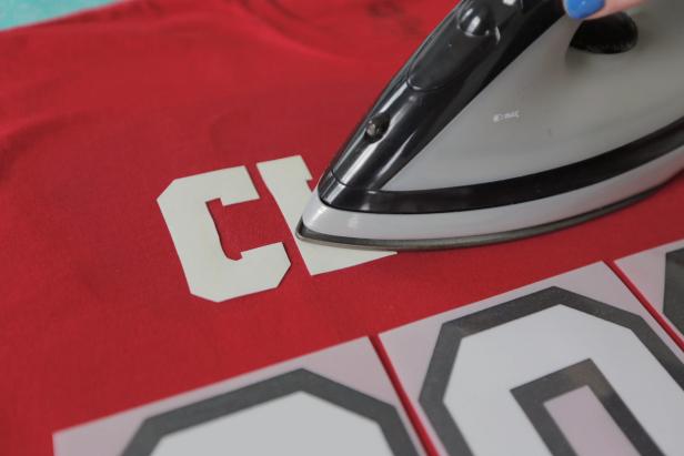 Next, using a hot DRY iron, press the iron-on letters onto the t-shirt, by keeping the iron moving with steady, even pressure for about 60 seconds (or time indicated in your transfer kit’s directions). IMPORTANT: Make sure the steam setting is turned OFF. 