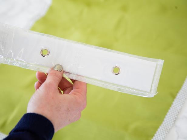 Step 4- Add Grommeted Top To hang the organizer on the back of the seat, add grommets along the top of the panel. Trim the grommeted strip off a vinyl shoe organizer, then add a bead of hot glue to the strip. Next, secure to the top of the fabric panel, adding duct tape along the backside for extra strength.