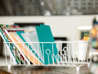 Organize your go-to documents in a repurposed dish drain. Outfit with pretty folders and color coordinated notebooks to keep the look chic. And don’t forget to stock the utensil cup with plenty of pens and pencils.