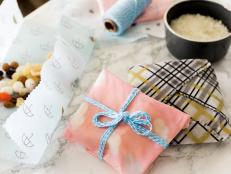 If you’re feeling guilty about all those plastic baggies you use, you’ll love these DIY reusable wraps. You’ll need beeswax pellets, fun cotton fabric, parchment paper, pinking shears and an iron. First, trim your fabric to the desired size, then lay an old towel over the ironing board. Place the fabric square on the towel, then sprinkle it with beeswax pellets. Next, place a large piece of parchment paper on top of the fabric square and pellets. Carefully use a hot, dry iron to melt the pellets into the fabric evenly. When dry, fold to your liking around snacks and sandwiches and tie off with washi tape or cotton twine.   HINT: You’ll need to retreat with wax every 15 or so uses. 