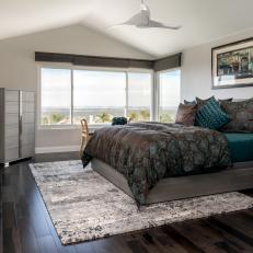 Master Bedroom With Wide-Plank Wood Floors and Stylish Fan