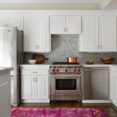 Kitchen With Stainless Steel Gas Range and Pink Rug