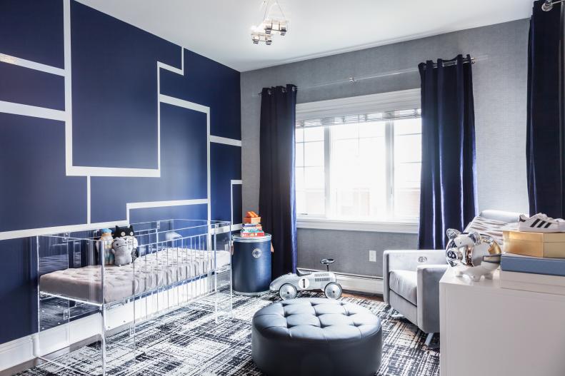 Artistic Nursery With Navy Blue Accent Wall and Clear Crib