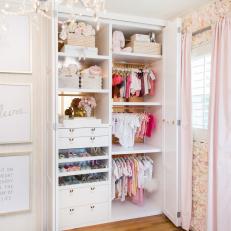Nursery Closet With Pink Silk Flower Wall and Custom Art