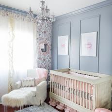 Glamorous Gray Nursery With Chandelier and Pink Accents