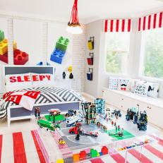 Boy's Red and White LEGO-Themed Bedroom With Play Table