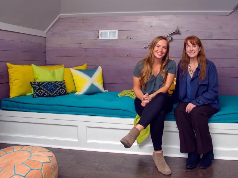Mina Starsiak (l) and Karen E. laine (r) pose in the refurbished bonus room as seen on Good Bones. The French mattress cushions provide a place for guests to sleep.