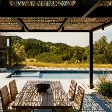 Rustic-Modern Outdoor Dining Room with Pool View