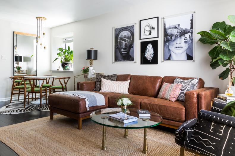 The living room is an open plan affair, with a view to the condo’s dining room and kitchen. Stein has opted for a soothing color palette of earth tones in her space, combining various shades of brown, black and forest green against a white backdrop. 