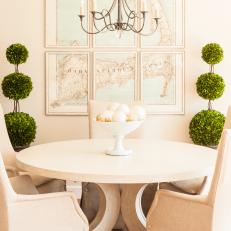 White Dining Room With Round Table and Triple-Ball Topiaries