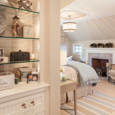 Attic Bedroom With Fireplace and Built-In Display Shelves