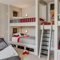 Bunk Beds With Red and White Linens Plus Central Ladder