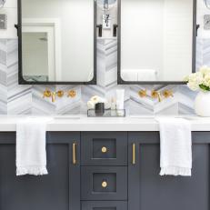 Blue and Gray Wall & Vanity With Brass Faucets and Hardware