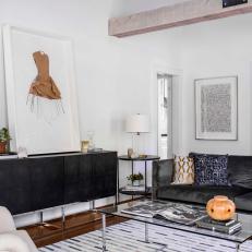 White Living Room With Dark Gray Sofa and Glass Coffee Table