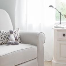 Gray Armchair and White Chest in Neutral Nursery