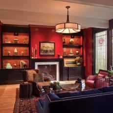 Red Living Room With Navy-Blue Sofa and Stained-Glass Window