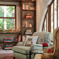 Seating Area With Armchairs, Bookshelves, and Arched Window