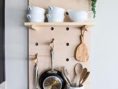 If your kitchen cabinets and drawers are overcrowded, create more storage space with this easy-to-make oversized pegboard shelving system. You can customize the shelves and pegs to stylishly display your favorite pots, pans and utensils.