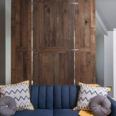Gray and Blue Apartment Living Area With Barn Door Partition