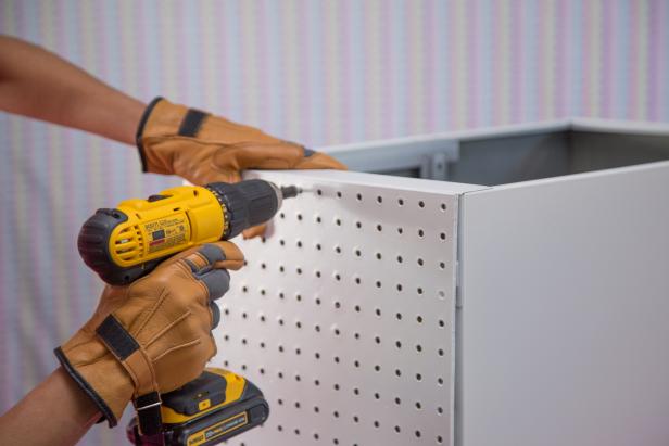 Drill the peg board to the side of the cabinet.