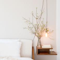 Modern Floating Nightstand With Industrial Modern Light Fixture and White Bed Linens
