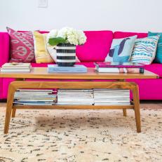Living Room With Bright Pink Sofa and Colorful Throw Pillows