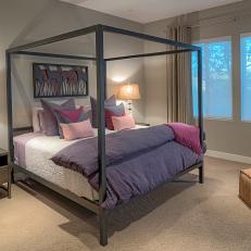 Beige Bedroom With Purple Bed Linens