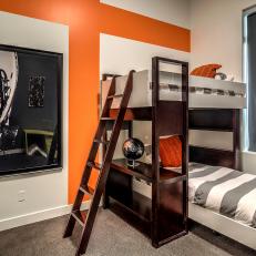 Contemporary Kids' Room With Orange Accent Wall and Bunk Beds