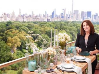 Picnics aren't just for parks and other pastoral settings. Just because you live in an apartment doesn't mean you can't host a high-end picnic on a balcony or terrace. Take advantage of the light and green surroundings and echo those features in your tablescape. Here trend expert Nancy Fire sets the scene for a Cast Shadows-themed urban picnic at her home in New York City.